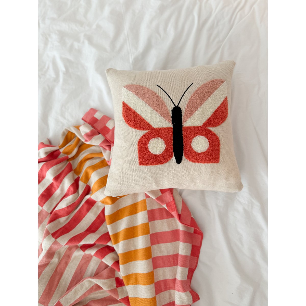 Butterfly cushion pink, soft cotton knitted with punchneedle embroidery.